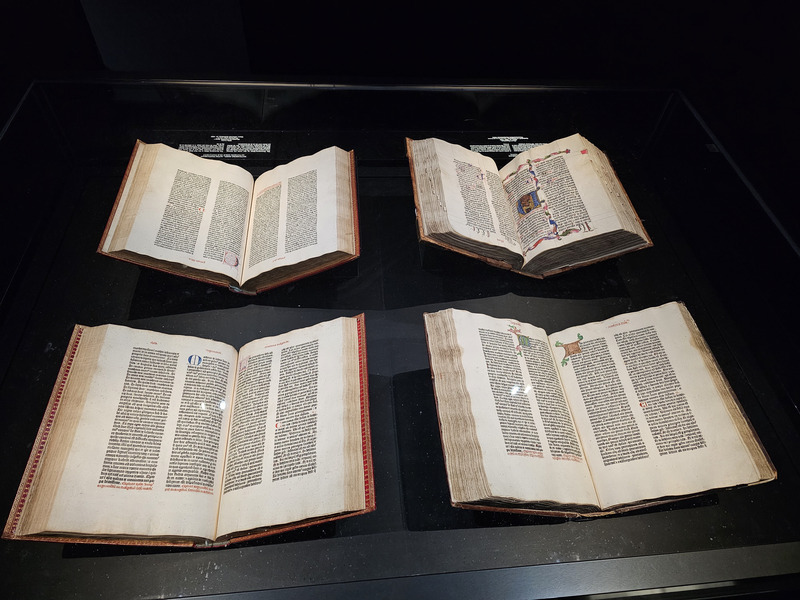 Four volumes making up one complete Gutenberg Bible, one half of one, and a volume printed later