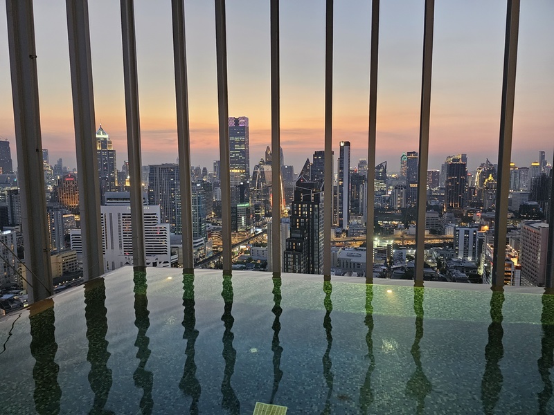 Bangkok skyline from a rooftop pool at dusk