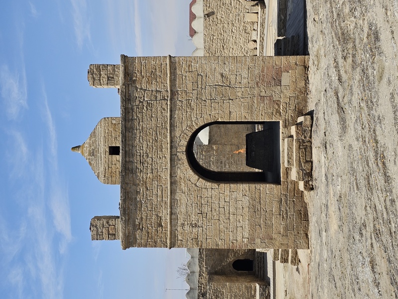 Atashgah Zoroastrian Fire Temple with an eternal flame burning inside an arched opening against a blue sky