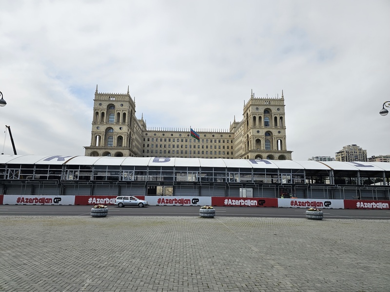 Government House in Baku, Azerbaijan, stands behind a Formula 1 track barrier displaying #AzerbaijanGP.