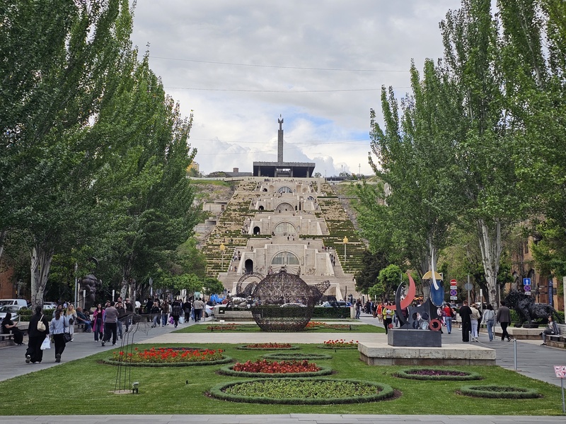 View of the Cascade Complex in Yerevan, Armenia, featuring the large staircase, sculptures, and the October Revolution monument at the top.