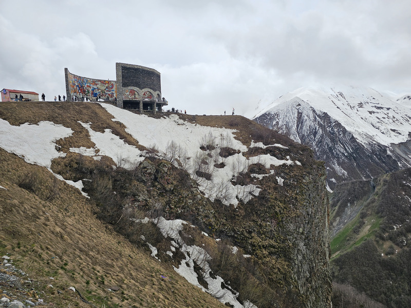 Russia–Georgia Friendship Monument above snowy Gudauri mountains.