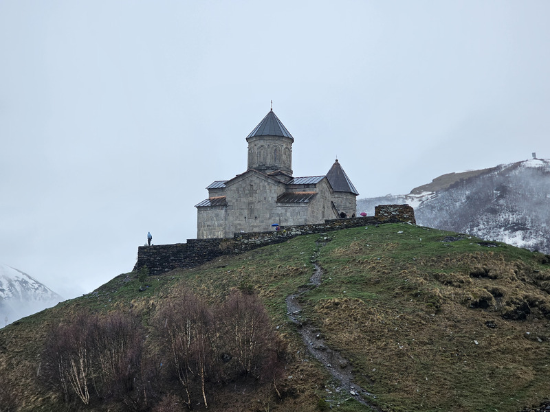 Gergeti Trinity Church on a misty mountainside near Stepantsminda, Georgia.